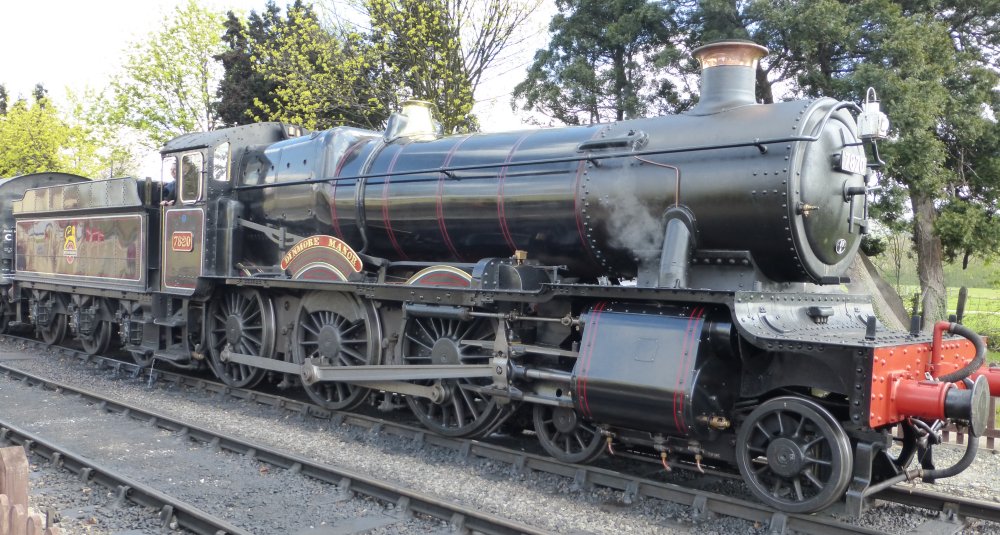 In classic black British Railways livery, Steam locomotive 7820 DINMORE MANOR GWR, a GWR Manor Class 4-6-0 at Toddington station on the Gloucester and Warwick Heritage Steam Railway