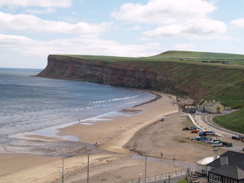Saltburn Beach and the characteristic cliff profile, the high cliffs of Boulby in the distance.