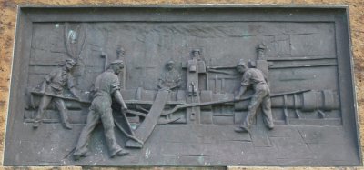 Working the huge strips of iron or steel in the iron works.