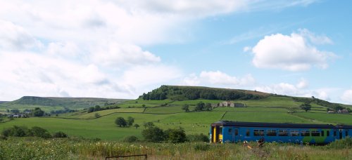 The Northern Rail train passing Danby Castle and Little Fryup Dale.