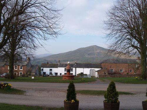 Dufton Village, with Dufton Pike in the background, the Stag Inn on the left and the old water fountain in the centre.