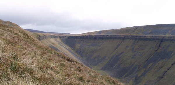 Surrounded by limestone hills, High Cup Nick is a ridge of hard volcanic rock which is part of the Whin Sill.