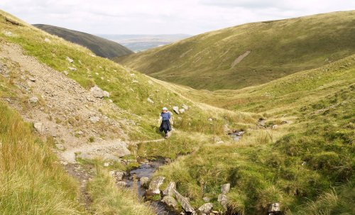 Above the Cautley waterfalls you follow the stream up a low valley and head for the Calf ...