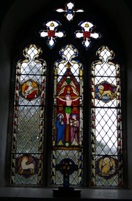 All Saints Church triple-light east stained glass window above the altar - River Eden walk, Bolton Village near Appleby, Cumbria, Northern England