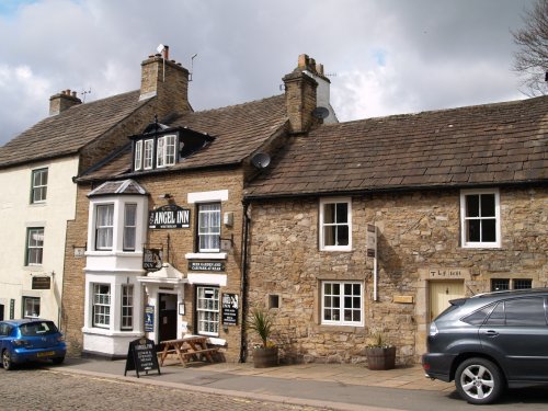 The building on the right is dated 1681, the Angel Inn 1611 and the white building on the left 1687. Alston Town, Cumbria, North Pennines, Northern England