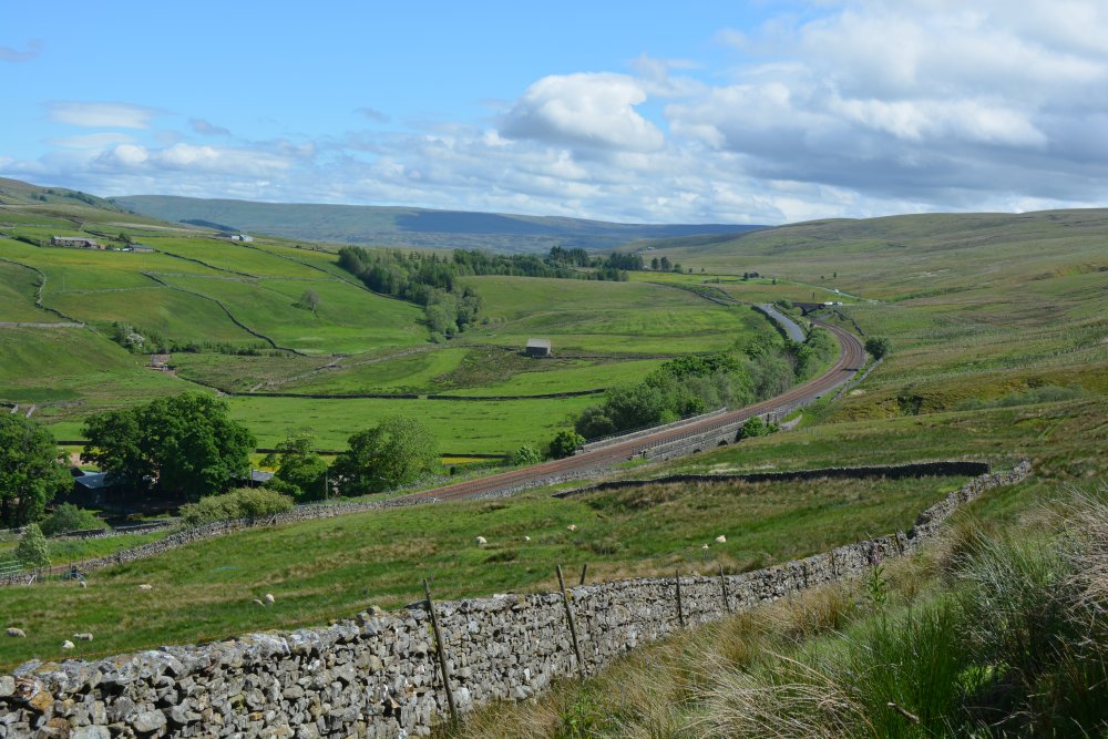 curve of the Carlisle-Settle line as it winds its way down into Aisgill by Aisgill Farm walking on Mallerstang Common, Cumbria, England