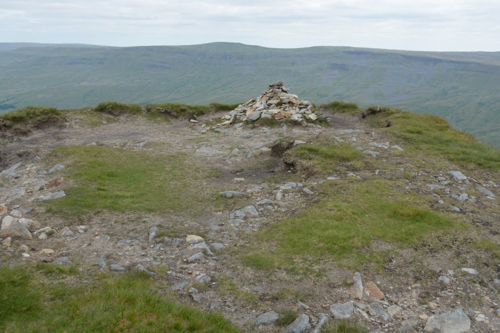 cairn and prehistoric tumulus on the summit of the Nab Climbing up Wild Boar Fell, walk from Mallerstang Dale, Cumbria, England