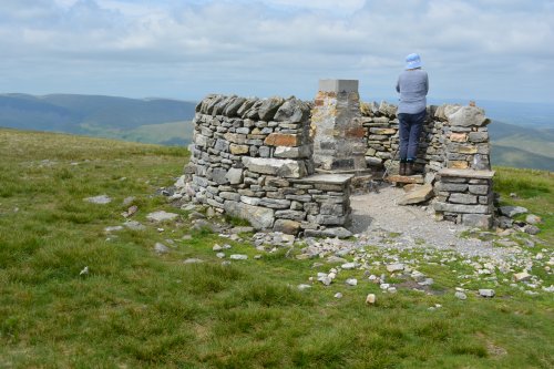 shelter and trig point at the summit Climbing up Wild Boar Fell, walk from Mallerstang Dale, Cumbria, England