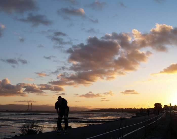 14. Sunset over Dublin bay viewed from the Clontarf-Sutton road as a skateboarder flashes by!