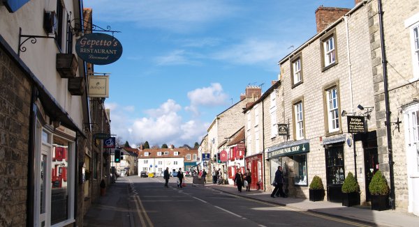 Bridge Street, one of Helmsley's attractive streets of stone built shops, pubs and cafe's just off Market Square in the distance.
