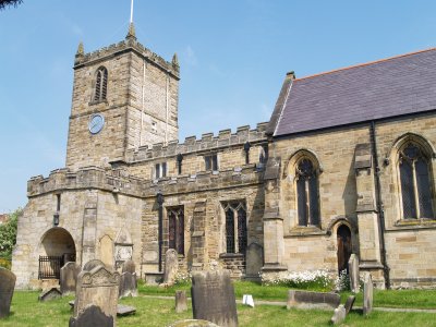 The massive porch is in the English perpendicular style.