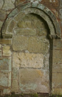 an early Norman archway door in the north wall