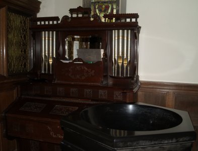 The small organ, by the font, is very ornamental' with its pretty 'tiny' pipes.