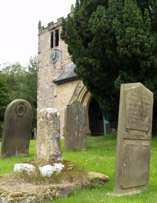 The stump of the old Saxon Market Cross by the south entrance door shows the ancient origins of the church.