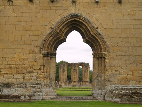 Detail of the west front door entrance-gateway (Gothic) with the east front windows (Romanesque) in the distance.