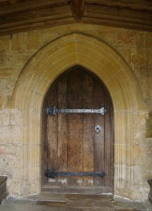 The richly early 15th century carved pointed arches of the main south door entrance, fitted with what seems an equally ancient door ....