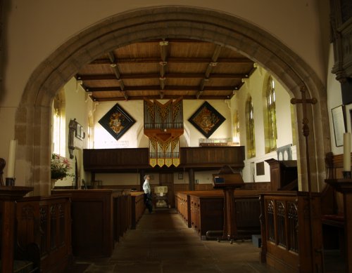 Looking west down the nave to the back gallery in front of the arch into the base of the tower.