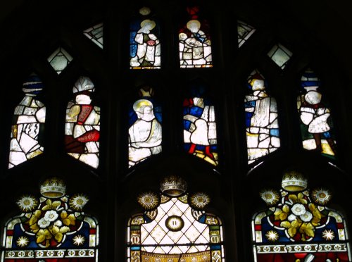 The top traceries of the north facing stained glass windows contains sections of the original medieval glass, whose simplicity contrasts with the more elaborate Victorian stained glass below.
