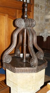 The font is relatively modern but the cover is a splendid piece of 17th century wood carving.