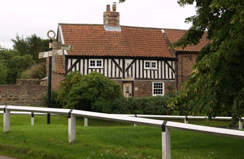 Black Bull Cottage across the road from St Nicholas in the centre of Husthwaite Village.