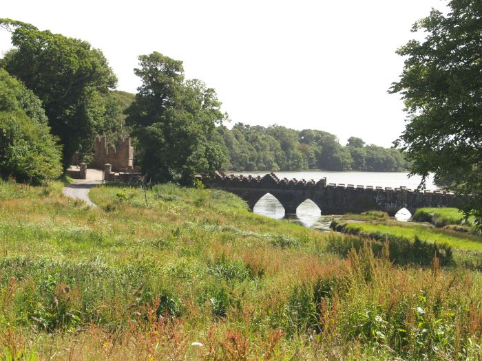 The 18th century battlemented Tintern Bridge over the inlet into which Tintern Stream runs, part of Bannow Bay Tintern Abbey, Wexford, Ireland