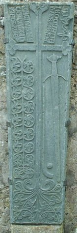 There are splendid carvings on the cross and some tombstones inside the ruined church.