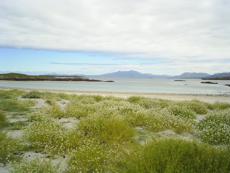 A white sandy beach on Inishbofin, looking landward to the Hills and Mountains of Connemara.