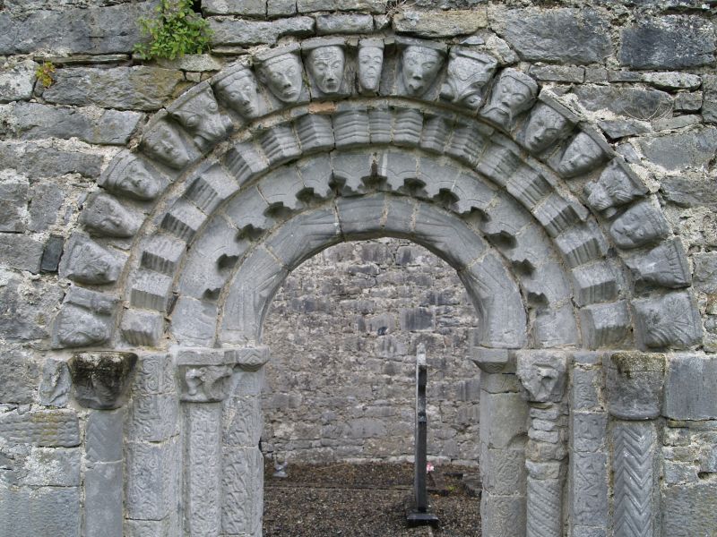 The fine Romanesque doorway of four orders surrounded by a row of animal and human heads - Dysert O'Dea Abbey near Corofin, County Clare, West of Ireland