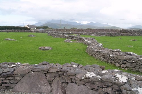The remaining stone walled outline of the early Christian monastic enclosure - Early Christian sites, Dingle Peninsular, Co. Kerry, West of Ireland