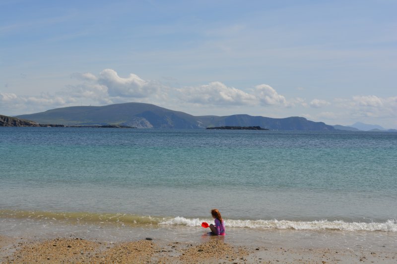 Child playing on the very safe Keem Beach, Achill Island, Co. Mayo, Ireland