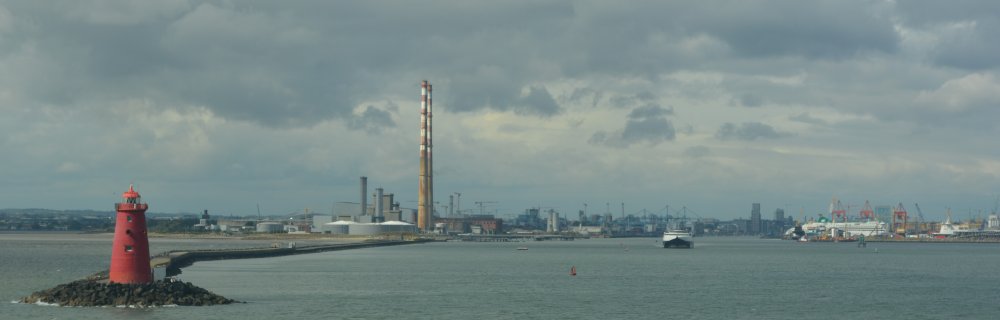 The iconic twin towers (disused Poolbeg chimneys) at the ESB power station, the breakwater and lighthouse entrance to the Port of Dublin