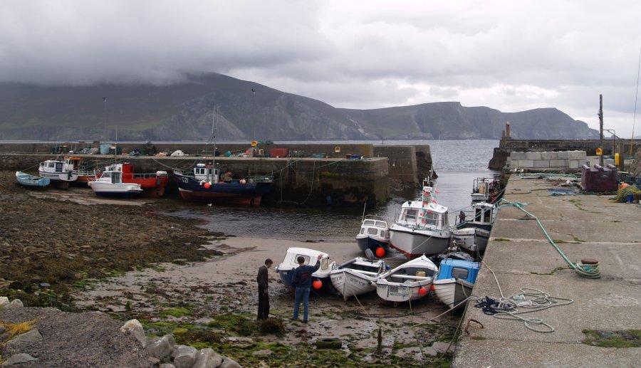83. Boats at the pier of Purteen harbour near Keel Beach, with Minaun Cliffs beyond, Achill Island, Co. Mayo, Ireland.