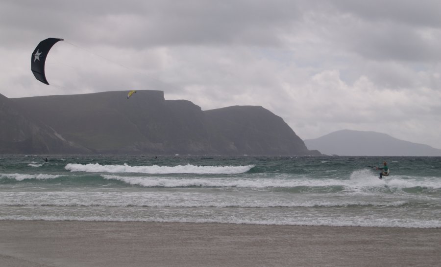 86. Kiting water sport at Keel Beach, Achill Island, Co. Mayo, Ireland. The two mile long Keel Strand is a favourite location for kitesurfing on Achill Island using a kiteboard like a surfboard and a water kite.