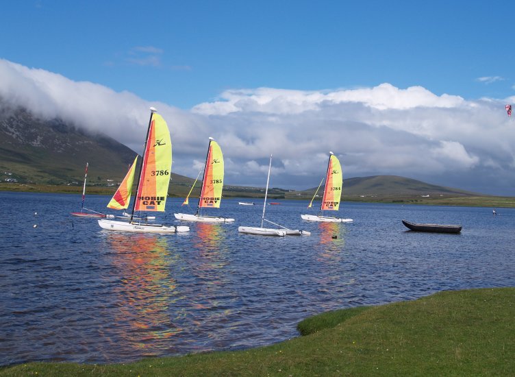 107. Sailing boats (yachts, dingies?) on Keel Lough (Keel Lake,), near Keel village, Achill Island, Co. Mayo, Ireland. Note an old currach boat and a water kiter on the right.
