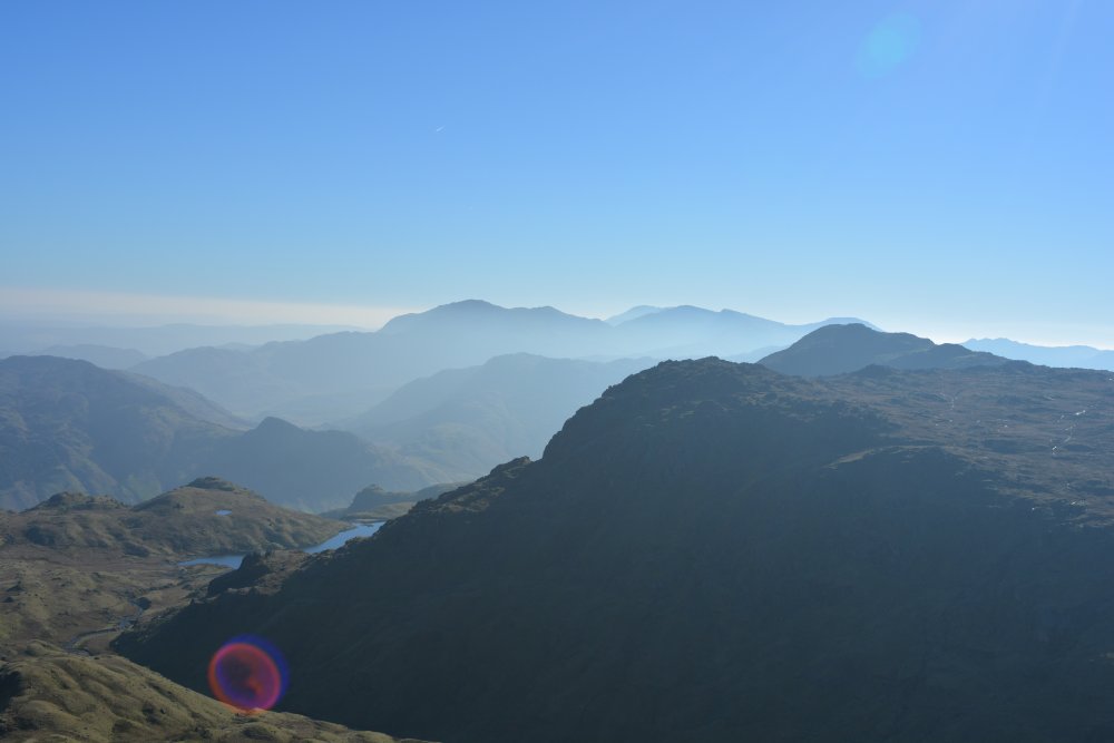 View of Langdale from summit of Sergeant Man circular walk on hills high above Easedale Tarn, Cumbria, England