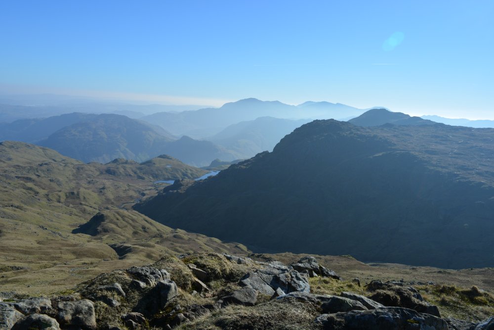 View of Langdale Pikes from top of Sergeant Man circular walk on hills high above Easedale Tarn, Cumbria, England