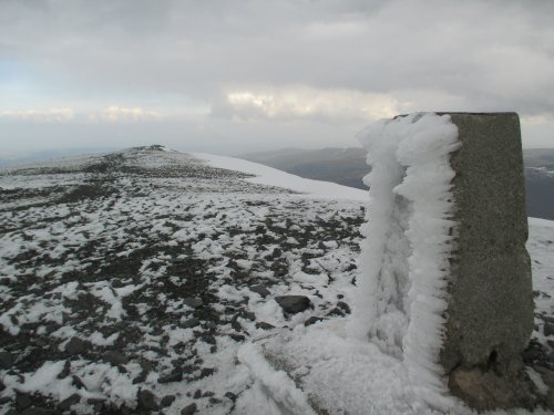 The old trig point on Skiddaw summit Climbing Skiddaw from Millbeck, Cumbria, Lake District National Park, England