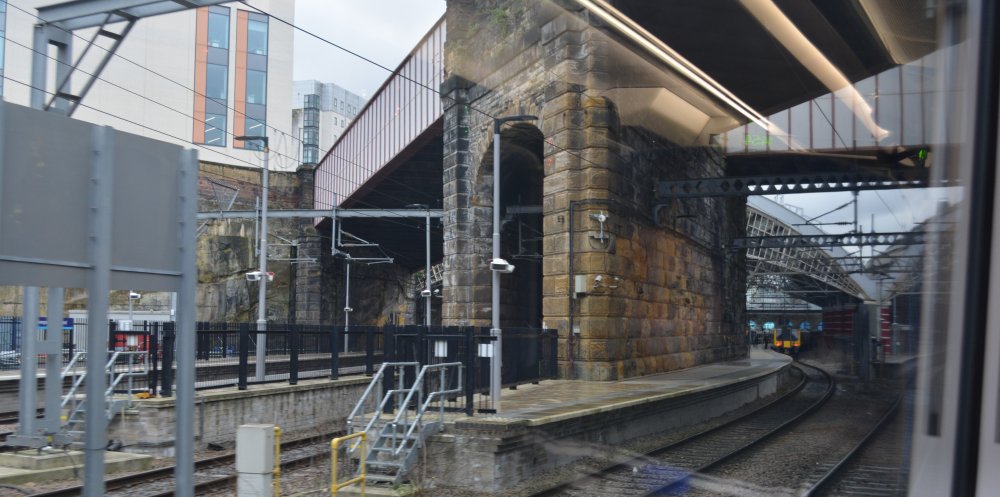 The approach to Liverpool Lime Street Station platforms, glimpse of the two great arches of the trainshed