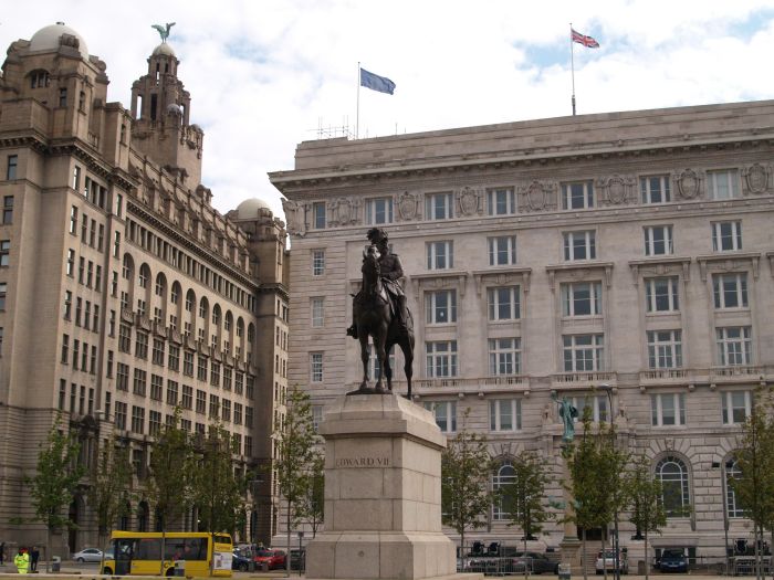 The Cunard Building is a great square block with sculptural features relatively small and neat. The frame is reinforced concrete and was begun in 1913 and includes some neogothic detailing. In front is the equestrian statue of Edward VII by Sir W. Goscombe John Pier Head Liverpool