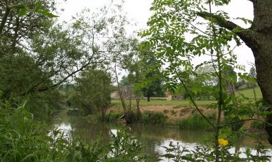 Eventually the ruins of Kirkham Priory begin to emerge through the trees across the river.