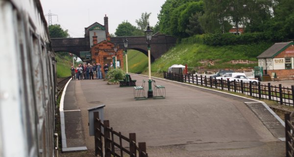 Heading north coming into Rothley Station platform. Note the tracks pass either side of the central platform and the characteristic GCR 'little house' of the station entrance on the bridge - The Great Central Railway, England, English Midlands