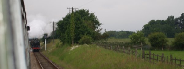 30777 Sir Lamiel (Ex Southern Railway-British Railways SR King Arthur Class 4-6-0) heading south at speed approaching Quorn and Woodhouse Station and passing fields of poppies. - The Great Central Railway, England, English Midlands