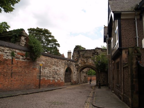 Looking down the medieval street through the arched gateway to The Newarke Houses.