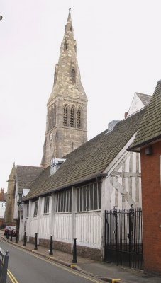 The Guildhall with the tall spire of St Martin's Cathedral Church towering above it.