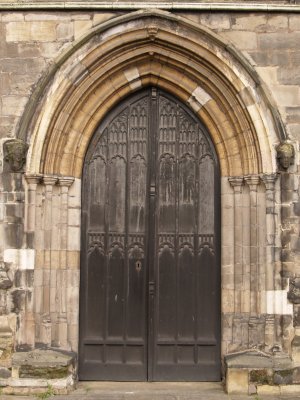 The ornately carved arches of the west door of St Margaret's medieval Church.