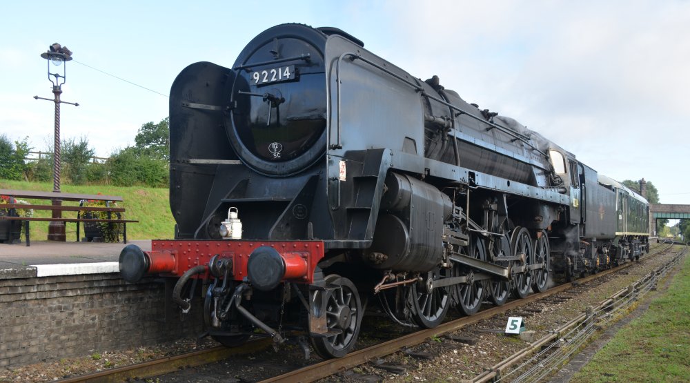 9F 2-10-0 freight locomotive 92214 (with D5054) travelling light south through Quorn and Woodhouse station, Great Central Railway heritage weekend 'Railways at Work' (GCR August 2023)