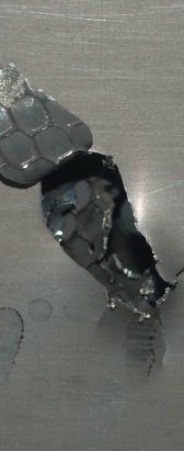 The picture shows a meteor damaged panel, a constant danger for any space station. The high speed impact of even a tiny meteorite can cause severe damage to the structure of any orbiting space station or satellite. The National Space Centre, Leicester, England, English Midlands