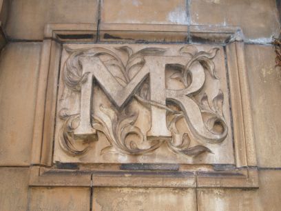 Trainspotting Leicester Station: The proud initials of the Midland Railway, carved in stone from the wall opposite Leicester Station entrance in London Road.