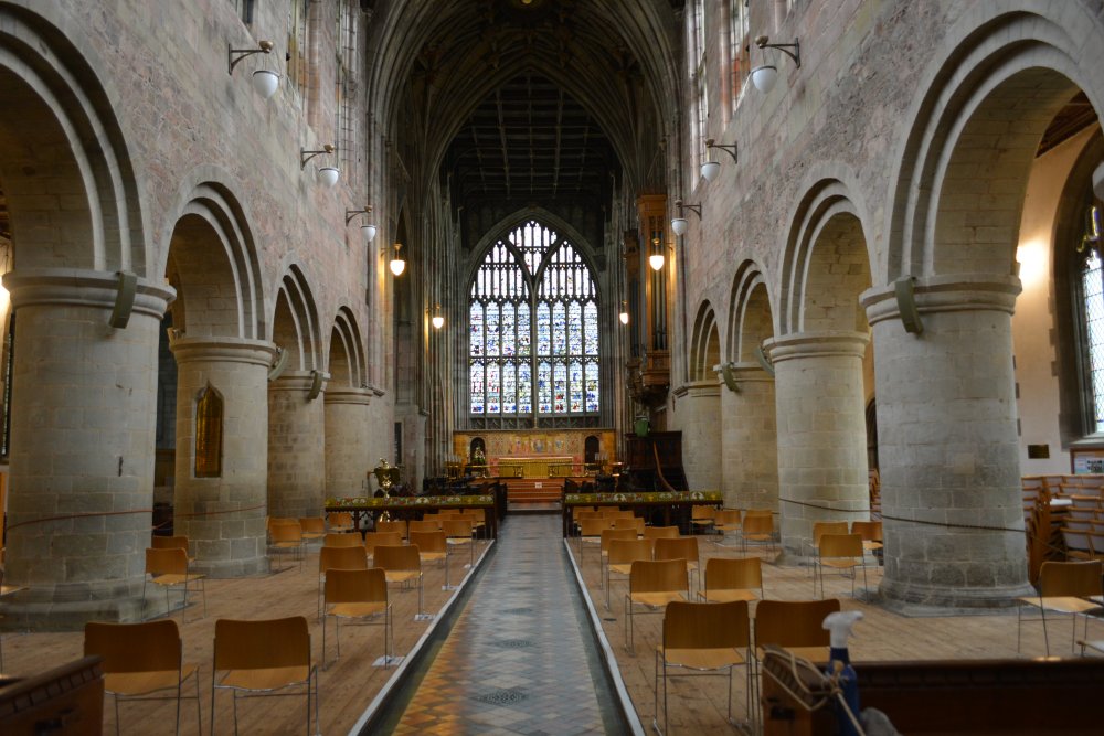 Looking east down nave of Great Malvern Priory Church Romanesque columns on either side Great Malvern Priory Church Worcestershire England