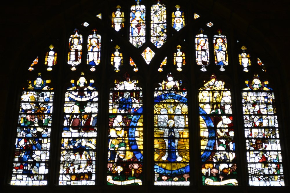 Details of the stained glass panels of the Magnificat Window Great Malvern Priory Church Worcestershire England